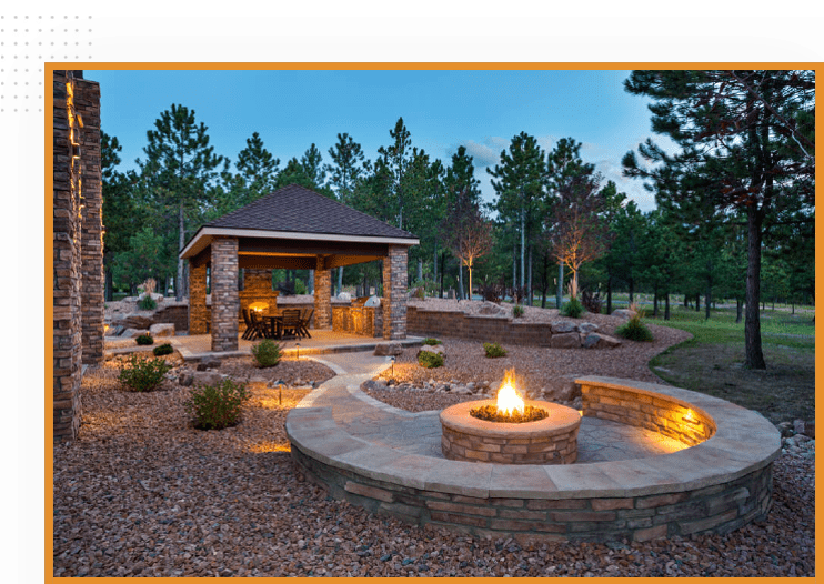 A fire pit in the middle of a garden.