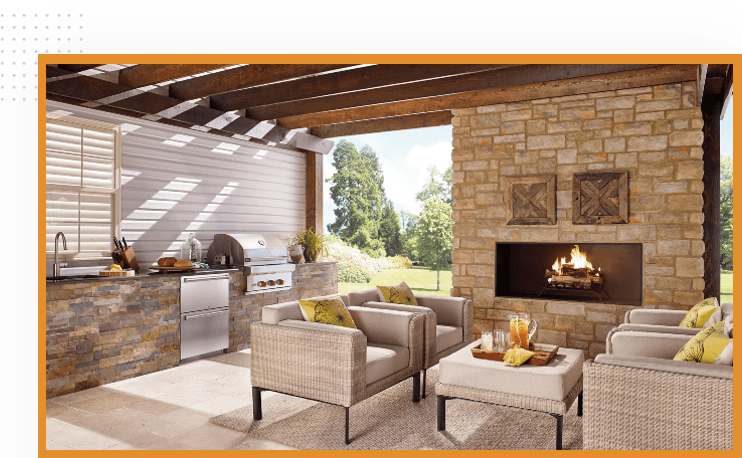 A patio with furniture and an outdoor fireplace.